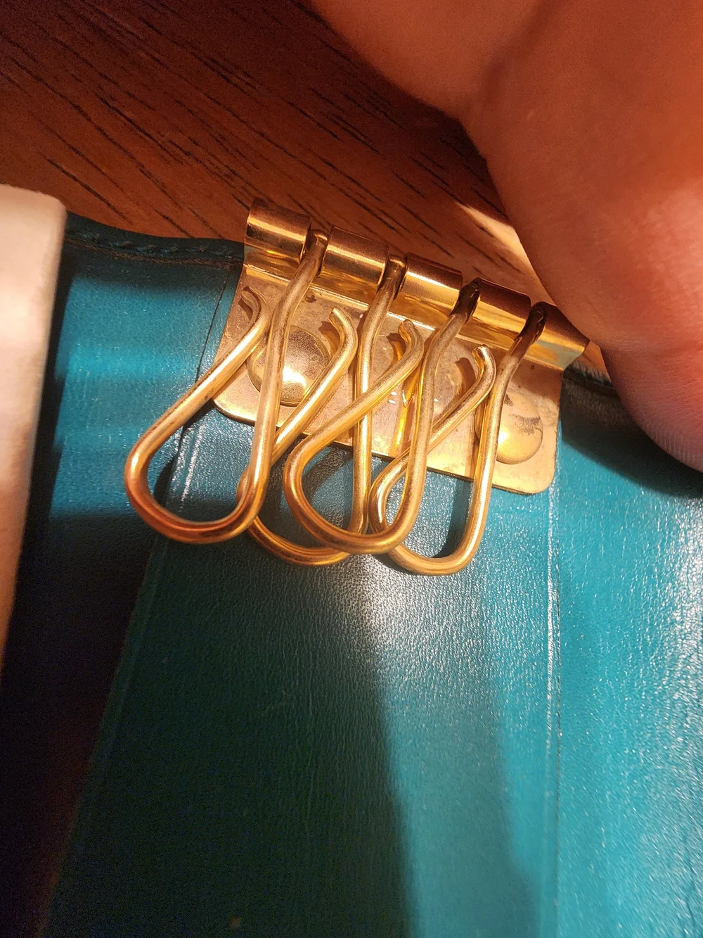 vintage Gucci teal leather key case featuring a distinctive cabochon stone